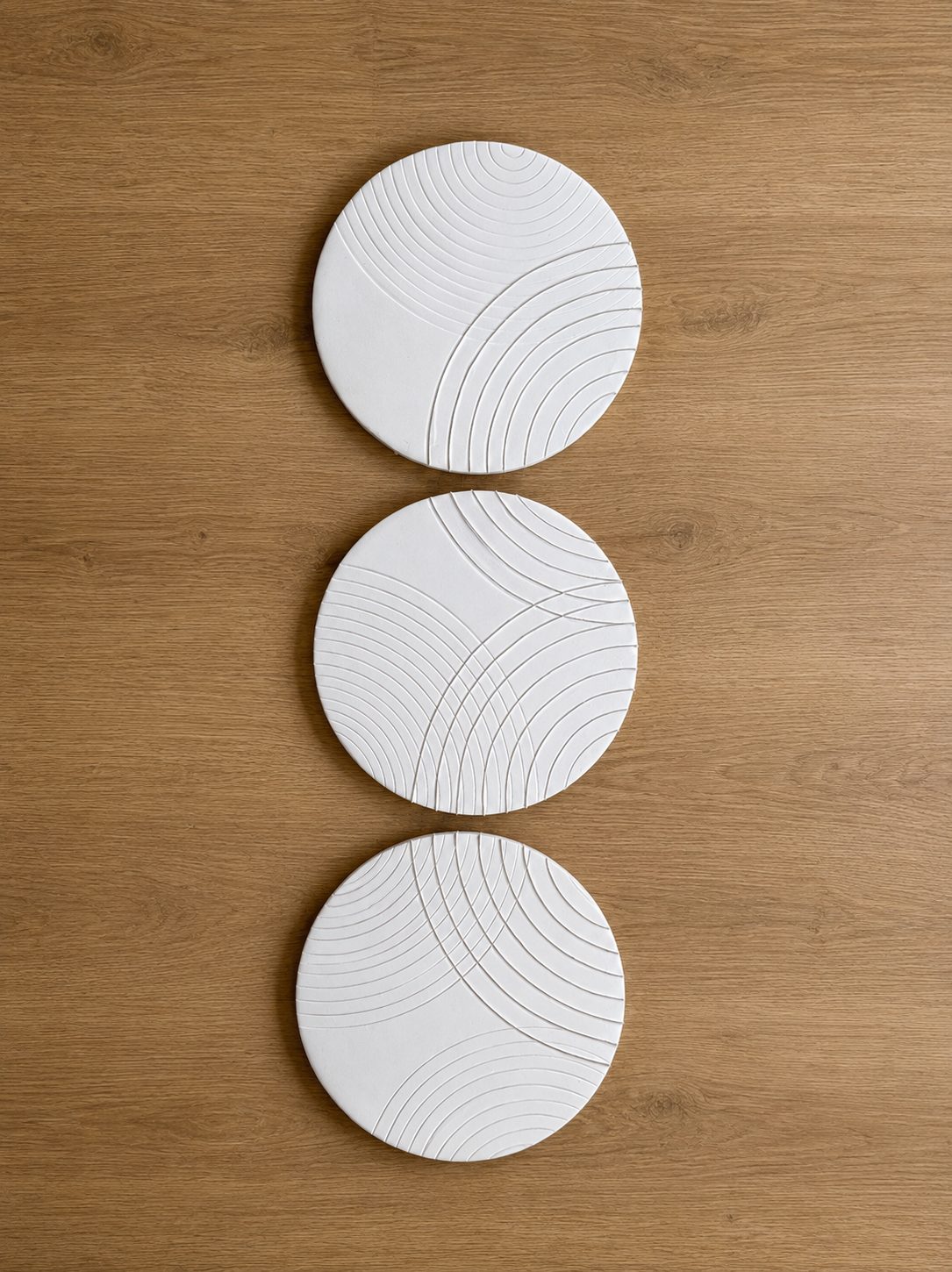 Circular textured plaster relief trio